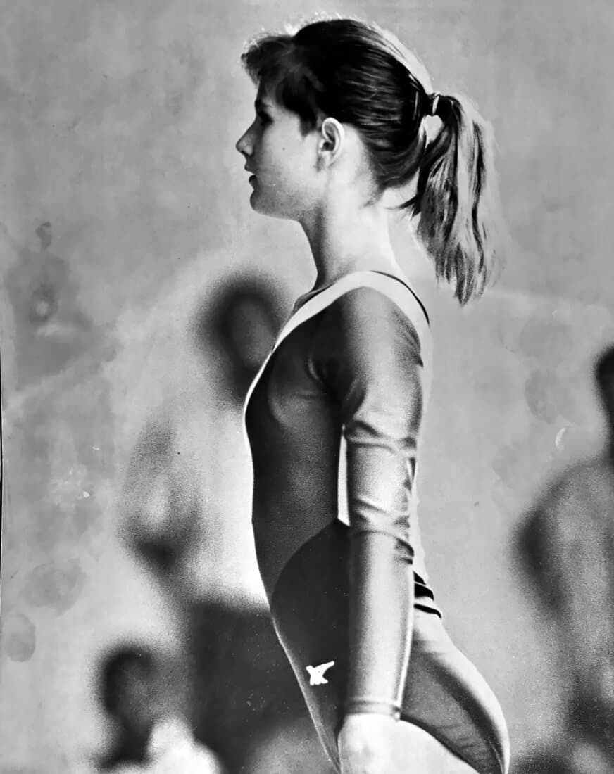 Profile portrait of Kristine in a competition leotard, hair in a ponytail